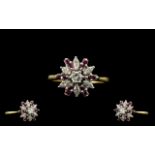 18ct Gold Diamond and Ruby Set Ladies Ring of starburst design. Marked 750-18ct. The marquise shaped