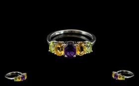 Amethyst, Citrine and Peridot Band Ring, an oval cut amethyst of .