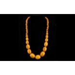 Amber Butterscotch Colour Bead Necklace. Of Graduated Barrel Form. Approx Length 24 Inches.