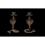 A Pair of Indian Brass Style Painted Candlesticks in the form of cobras. Each measuring 18cms high.