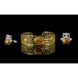 Two Natural Honey Jasper Set Items comprising a honeycomb and bee cuff bangle and an owl ring; the