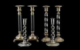 Three Sets of Silver Plated Candlesticks the first with glazed stems on a square base,