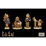 Four Hummel Figurines comprising Boy with Umbrella; Cherub with music stand and birds;