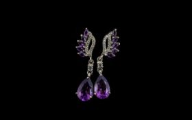 Amethyst Drop Earrings, each earring comprising a pear cut deep purple amethyst of 2.75cts,