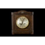 Art Deco Oak Cased Mantle Clock. Of square form. with silvered dial and Arabic Numerals.