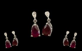 Ruby Pear Drop Earrings, each earring having a pear cut solitaire of 1.