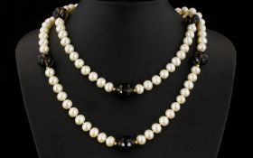 A Cultured Pearl And Topaz Bead Necklace With 14ct Gold Clasp Very long, elegant necklace comprising