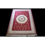 A Large Woven Silk Carpet Abusson rug with red ground and with traditional floral and foliate