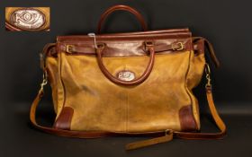 A Traditional Leather Holdall by Koy in two-tone tan and dark chestnut leather.