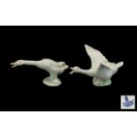 Two Lladro Figures of Geese. One with spread wings, one standing, both in 'honking' pose.