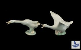 Two Lladro Figures of Geese. One with spread wings, one standing, both in 'honking' pose.