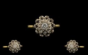 18ct Gold and Platinum Diamond Cluster Ring set with round cut diamonds in a flower head setting.