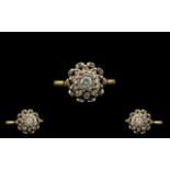 18ct Gold and Platinum Diamond Cluster Ring set with round cut diamonds in a flower head setting.