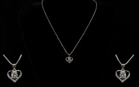 A Contemporary Silver And CZ Set Pendant Necklace Fine link chain with open heart pendant set to the