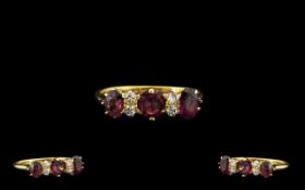 18ct Gem Set And Diamond Dress Ring set with three purple faceted stones between four diamond