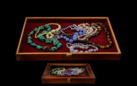 Collection of Vintage Beads housed in a wooden and glass display box.