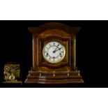 A Modern Mahogany Finish Chiming Mantle Clock white chapter dial with Roman Numerals.