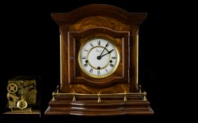 A Modern Mahogany Finish Chiming Mantle Clock white chapter dial with Roman Numerals.