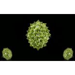 Peridot Large Oval Cluster Ring, a large cluster of oval and round cuts of peridot totalling 6.5cts,