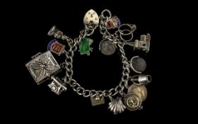 A Nice Quality Vintage Silver Bracelet Loaded with 15 Silver Charms.