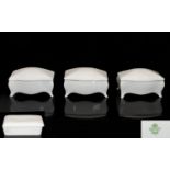 Shelley White China three (3) small oblong boxes with lids, raised on feet,