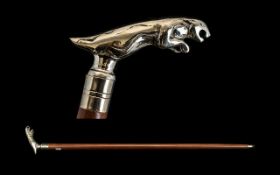 A Walking Stick with a polished chrome Jaguar mascot screw off top. Please see accompanying image.