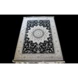 A Large Woven Silk Carpet Keshan rug with black ground and grey border with traditional floral and