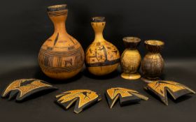 African Art. A small mixed lot to include 2 incised Gourds, coconut cups, and four wall plaques.