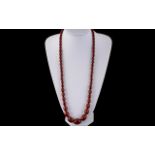 A 1920's - Attractive Cherry Amber Long Graduated Beaded Necklace with Gold Tone Clasp.