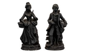 Two Victorian Style Figurines depicting a male and female, in black coloured finish,