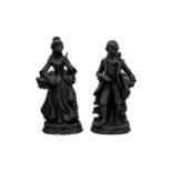 Two Victorian Style Figurines depicting a male and female, in black coloured finish,