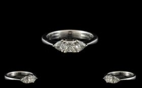 18ct White Gold And Diamond Three Stone Ring Set with central princess cut between two trillion