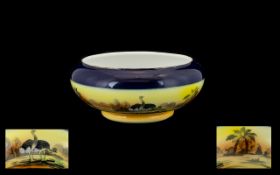 Noritake Bowl decorated with an Oasis scene with Ostriches. Thick royal blue band to rim.