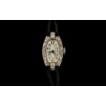 A Ladies Platinum Diamond Cocktail Watch barrel shape case, milgrain set round cut diamonds,