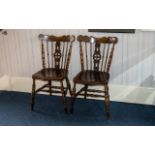 Two Antique Rustic Elm Kitchen Chairs in traditional spindle back design with central decorative