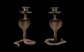 A Pair of Indian Brass Style Painted Candlesticks in the form of cobras. Each measuring 18cms high.