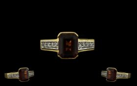 18ct Gold Garnet and Diamond Set Ring of Attractive Form. The Central Emerald Cut Garnets of Good