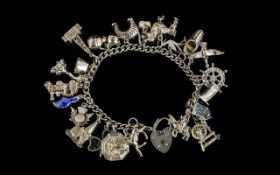 A Good Quality Silver Curb Bracelet Loaded with 22 Silver Charms ( Interesting Charms ) Both