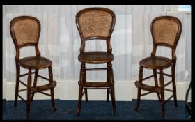 Child's High Chair in Mahogany with rattan seat and back, with foot support. Height 38".