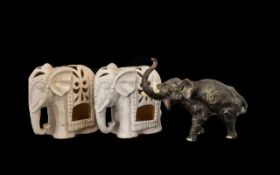 A Pair of Decorative Candle Burners in the form of Asian Elephants, 7.5 inches high.