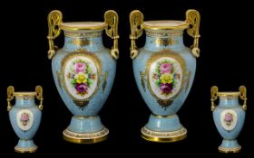 A Pair of Matching Victorian Vases in traditional style with twin gilt handles.