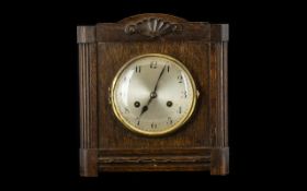 Art Deco Oak Cased Mantle Clock. Of square form. with silvered dial and Arabic Numerals. Complete