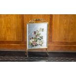 A Brass Fire Screen with hand painted mirror. Decorated with painted roses. Circa 1950s.