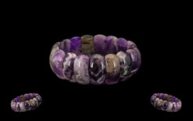 Sage Amethyst Bracelet, a bangle style bracelet comprising domed panels of amethyst in a wide