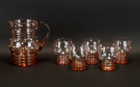 Mid 20th Century Glass Lemonade Pitcher & Beakers. Pale rose-tone shaped glass pitcher with ridge