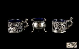 A Pair of Silver Salts with embossed cherub and scroll decoration. Both fully hallmarked for