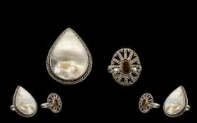 Mother of Pearl Set Ring and Amber Set Ring, a large pear cut piece of white mother of pearl in an