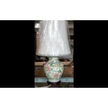 A Contemporary Oriental Ceramic Table Lamp Of baluster form, raised on shaped wooden base with