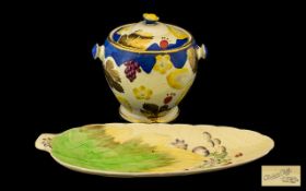 Clarice Cliff Leaf Shaped Pottery Dish yellow ground decorated with berries and flowers.