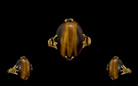 A 9ct Gold - Tiger Eye Set Dress Ring From The 1960's. Claw Setting, The Cabochon Cut Tigers Eye